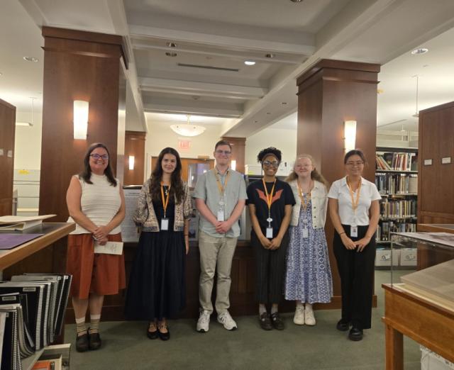 Summer 2025 interns standing in the Phillips library